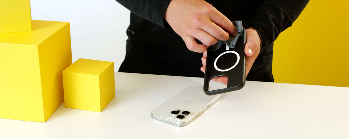 Person using a phone case maker on a smartphone with yellow blocks in the background