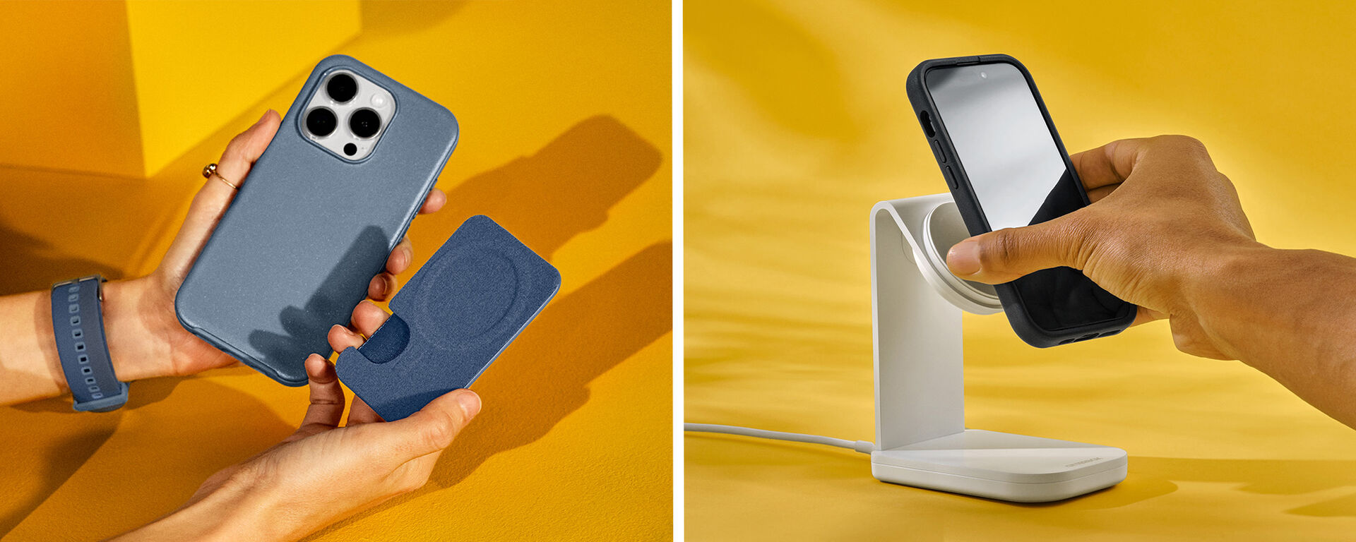 Person holding a phone with a blue case and another phone being charged on a stand against a yellow background.