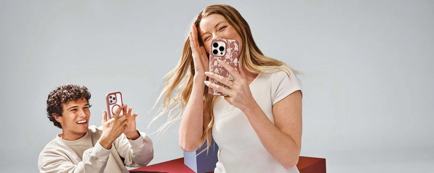 Two people using smartphones with glittery cases on a plain background