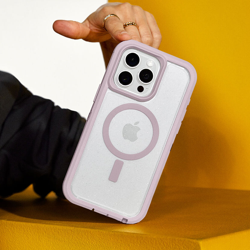 Phone case with Apple logo held by a person on a yellow background