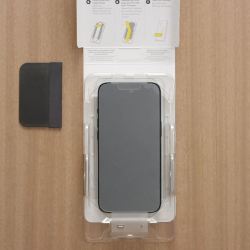 Phone screen protector in packaging on a wooden surface